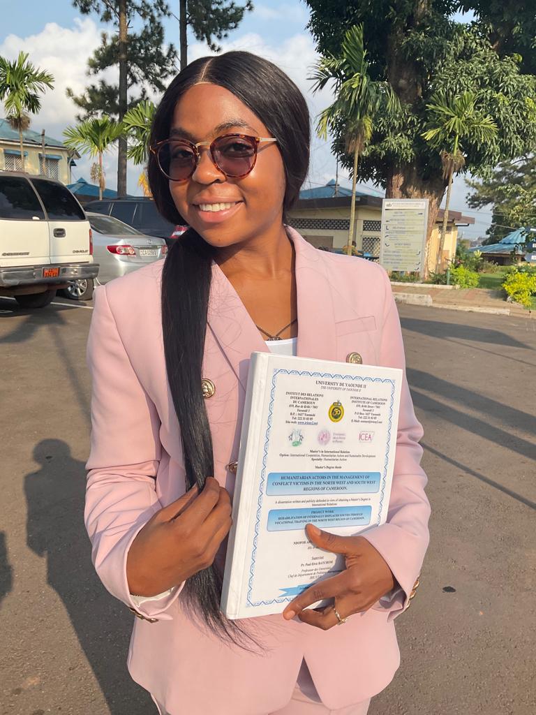 Ndofor holding her diploma