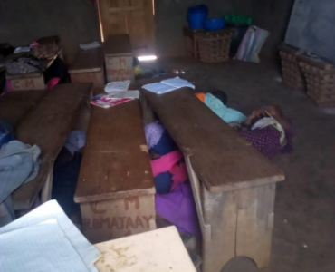 Students' belongings are around their desks.