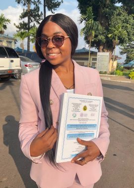 Ndofor holding her diploma